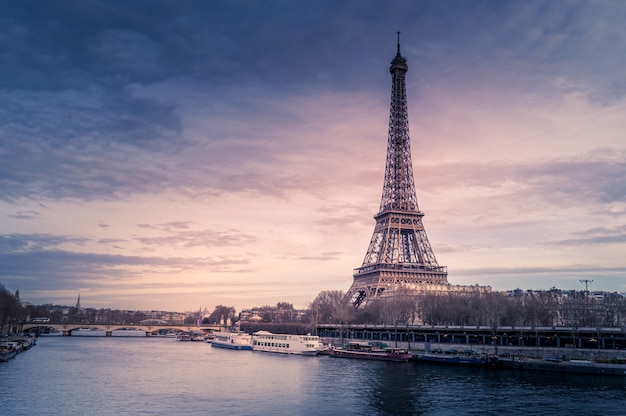 beautiful wide shot eiffel tower paris surrounded by water with ships colorful sky_181624 5118