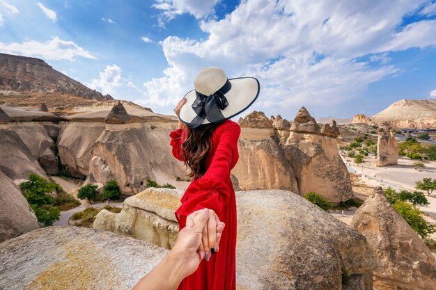 women tourists holding man s hand leading him fairy chimneys cappadocia turkey_335224 557 1